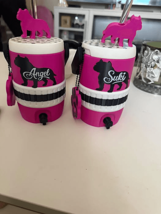 Two pink personalized custom dog breed can koozies with Angel and Suki names